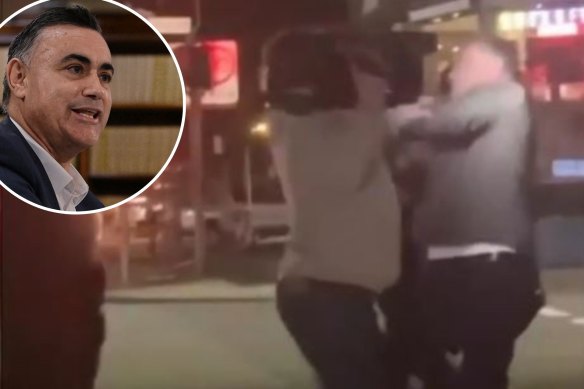 John Barilaro (inset) in an alleged scuffle with a cameraman in Manly. 