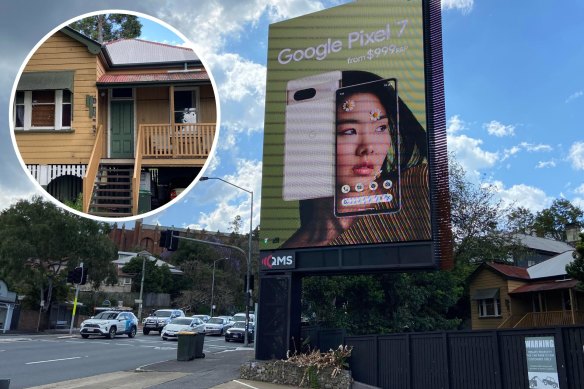 The controversial billboard, and original cottage, on Musgrave Road at Red Hill.