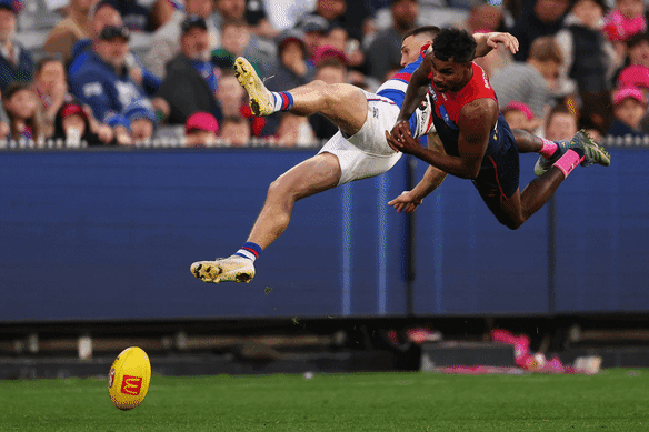 Heavy hit: Laitham Vandermeer and Melbourne’s Kysaiah Pickett collide.