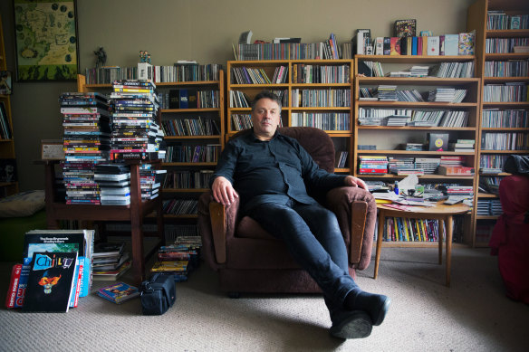 Martin Phillips in 2019 with some of his vast collection of books and CDs.