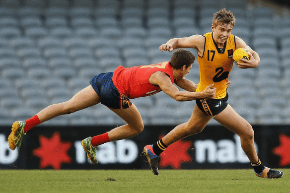 Patrick Cripps bursting clear for Western Australia in his draft year (2013), and showing the same trademark style more than a decade later as Carlton skipper.