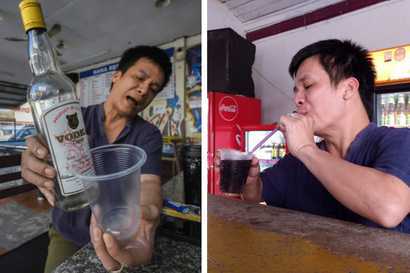 Nana Backpacker Hostel manager Duong Duc Toan pours himself a drink from a bottle of Tiger Vodka and finishes it.
