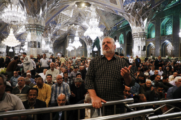 Iranians pray for President Ebrahim Raisi at Imam Reza Shrine in the city of Mashhad on Sunday.