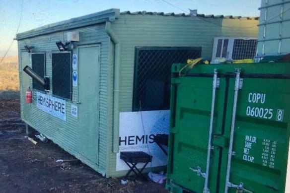 A temporary building seen on the Canyonleigh site that is branded with the Hemisphere Constructions logo.