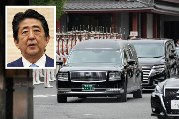 The vehicle carrying the body of former Japanese Prime Minister Shinzo Abe (inset) leaves Zojoji temple after his funeral in Tokyo on Tuesday.