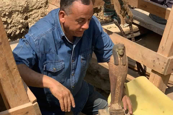 Mostafa Waziry with an artefact found near the Step Pyramid of Djoser in Saqqara, south of Cairo in 2020.