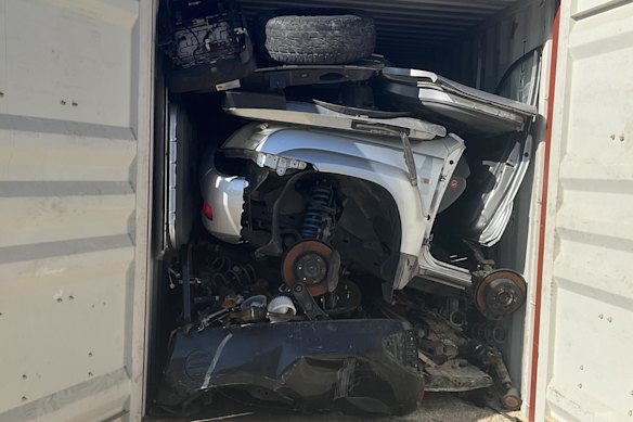 The vehicles were hidden behind car parts in the shipping containers. 