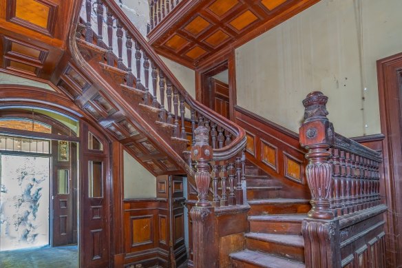 Red timber staircase inside the heritage-listed Lamb House at Kangaroo Point.