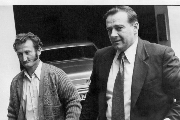 Peter Pasquale Macari (left), defendant in Qantas extortion cases escorted into central court September 29, 1971. 