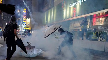 Protesters react to tear gas during a confrontation with police.