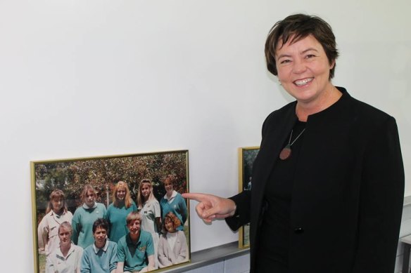 Ms King at Safety Bay High School with a photo of herself attending the school.