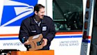 A US Postal Service employee loads parcels outside a post office in Wheeling, Illinois.