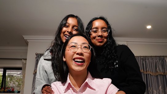 Sisters Sloka and Laysa pose for a photo with their tutor Sophia Ao, who has helped them achieve great school results for the select entry exams.