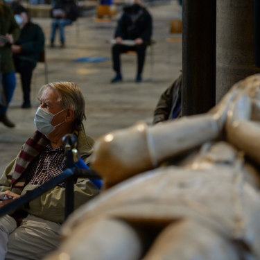 Patients wait in the cathedral’s historic nave for 15 minutes before they are allowed to leave. 