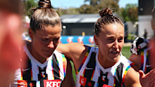 Ruby Schleicher of the Magpies speaks to the team.