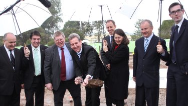 In 2013, then premier Barry O'Farrell and Gladys Berejiklian turn a sod to mark the signing of contracts for the metro line.  