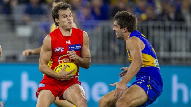 Crunch time: Gold Coast's Jack Bowes prepares to fend off West Coast's Andrew Gaff.