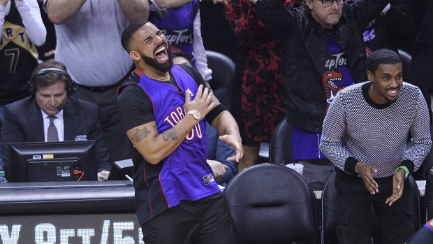 Huge Toronto Raptors fan Drake reacts courtside.