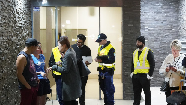 Residents evacuating Mascot Tower last Friday after receiving a letter from the building manager saying they had until 9pm to leave the complex.