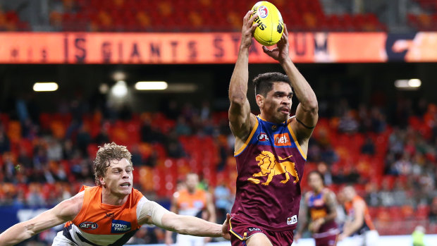 Big-time Charlie: Brisbane's Charles Cameron gets out in front of Greater Western Sydney's Adam Kennedy.