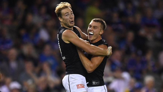 Bolt from the Blues: Harry McKay and Patrick Cripps (right) celebrate after a goal from the up-and-coming Carlton forward.