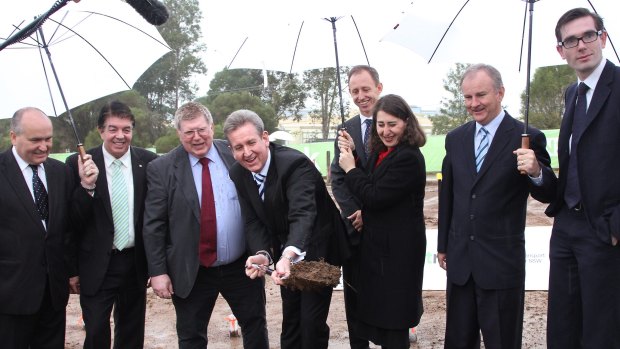 In 2013, then premier Barry O'Farrell and Gladys Berejiklian turn a sod to mark the signing of contracts for the metro line.  