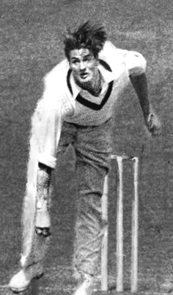 Keith Miller sends one down during a Test match.