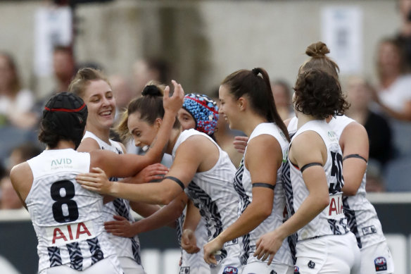 Aishling Sheridan and her Collingwood teammates celebrate a goal during round one. 