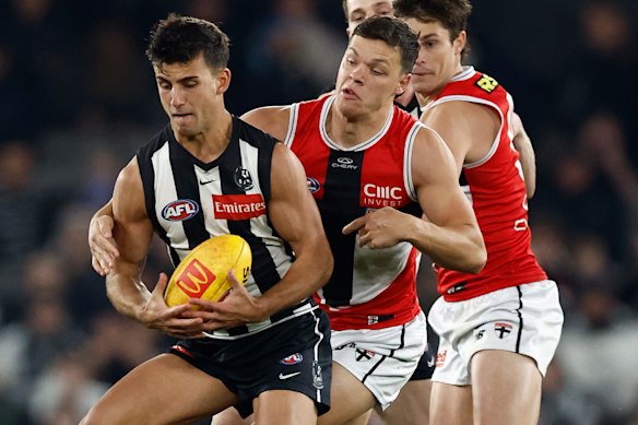 St Kilda’s Marcus Windhager keeps a close check on Magpies star Nick Daicos.