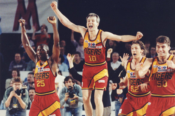 Andrew Gaze [middle] celebrates a win by his Melbourne Tigers in 1993 with Dave Simmons (25), Robert Sibley (52) and Mark Bradtke (50).