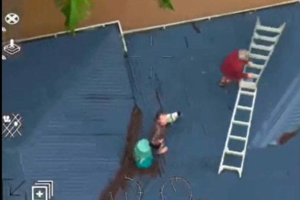 The view from a NSW RFS helicopter showing people stuck on their roof during the Lismore floods.