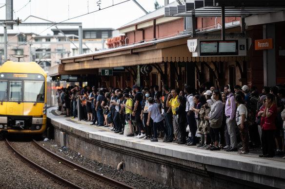 Commuters attempt to board trains at Parramatta Station during delays across the network yesterday.