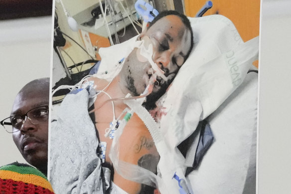 Family members and supporters hold a photograph of Tyre Nichols at a news conference.