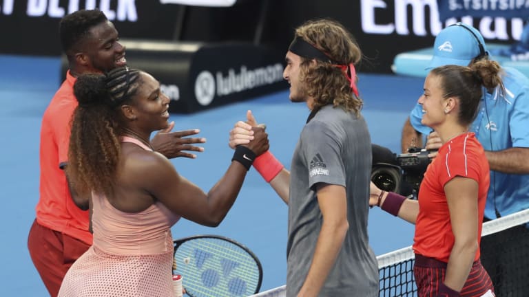 Mixed result: Stefanos Tsitsipass and Sakkari of Greece shake hands at the net after winning their mixed doubles match against Williams and Frances Tiafoe of the United States.