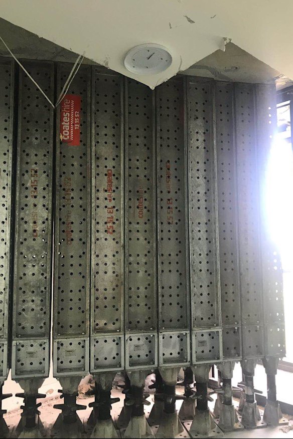 Props being used to brace the ceiling inside an apartment, which Icon said are "precautionary".