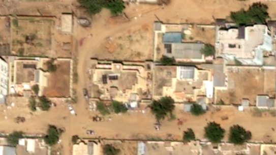 This satellite image taken by Airbus DS shows two reddish stains on the ground near what are likely RSF vehicles in El-Fasher on Monday.