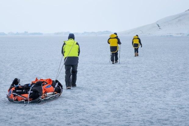 Hauling gear across a frozen epishelf lake back to camp.