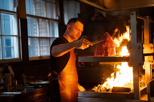 Chef Lennox Hastie cooking over flames at Firedoor.