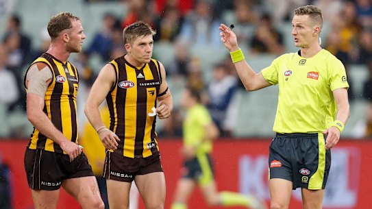 Hawthorn’s Tom Mitchell speaks to umpire Hayden Gavine after a 50m penalty was paid to the Cats on Easter Monday.