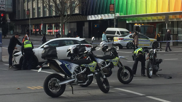 Police at the intersection of Elizabeth and Lonsdale streets after the motorcycle crash.
