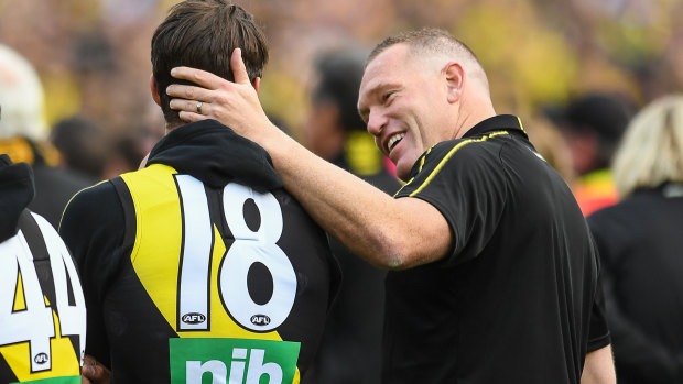 Alex Rance is consoled by assistant coach Justin Leppitsch at the grand final presentation ceremony.