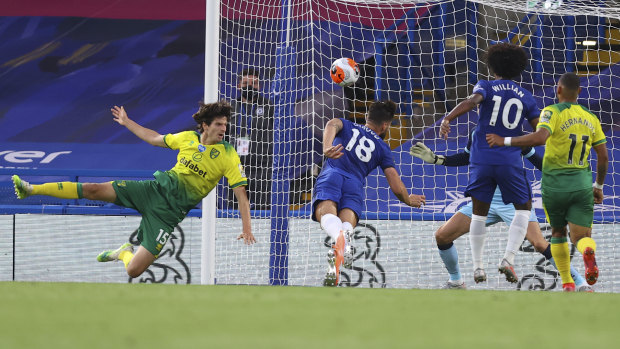 Chelsea's Olivier Giroud dives to head the ball into the net against Norwich.