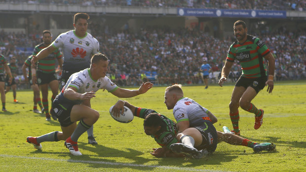 Procession: Alexander Johnston reaches out for another try to the Rabbitohs.