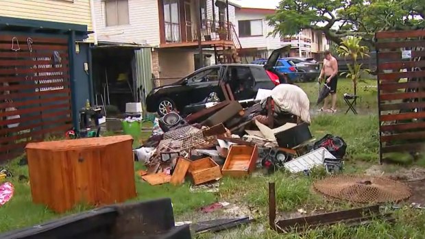 Skips had been sent to collect flood-damaged furniture that residents were throwing into their front yards.
