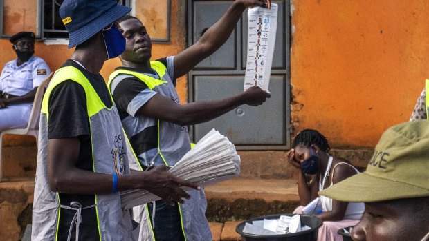 Election officials count the ballots after polls closed in Kampala, Uganda.