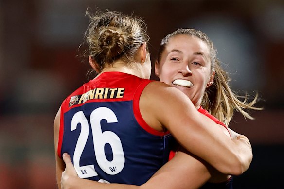 Mia Austin and Olivia Purcell share a moment in the Demons’ win over Hawthorn.