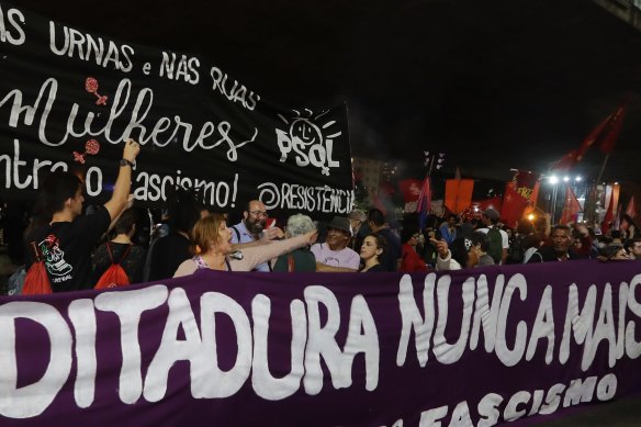 Demonstrators carry a banner that reads in Portuguese “Dictatorship never again,” during a protest against Jair Bolsonaro in Sao Paulo, in 2018.
