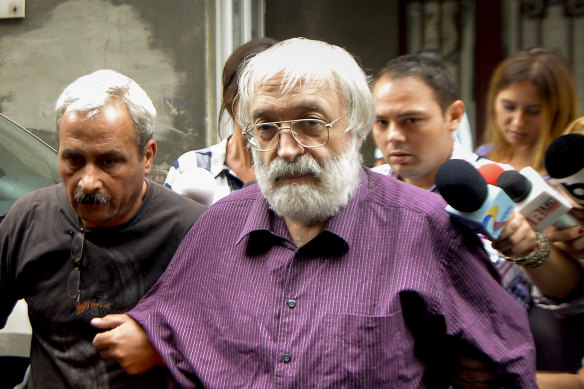 Romanian guru Gregorian Bivolaru is escorted to a vehicle, after a hearing at the Romanian Police headquarters in Bucharest, Romania, Wednesday, Aug. 24, 2016. French authorities arrested the leader of a multinational tantric yoga organization Tuesday Nov. 28, 2023 on suspicion of indoctrinating female followers for sexual exploitation. The Romanian guru at the heart of the Atman Yoga Federation was detained during a massive morning police operation across the Paris region. (AP Photo/Marian Ilie)