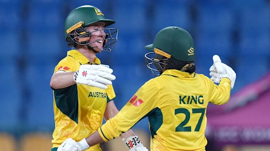 Beth Mooney congratulated by teammate Alana King after reaching her century in Australia’s match against Pakistan.