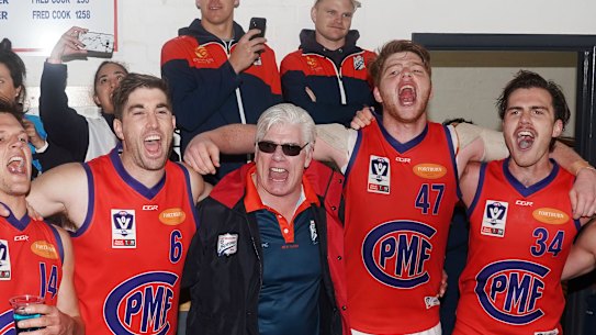 Port coach Gary Ayres sings the club song with his players after beating Footscray.